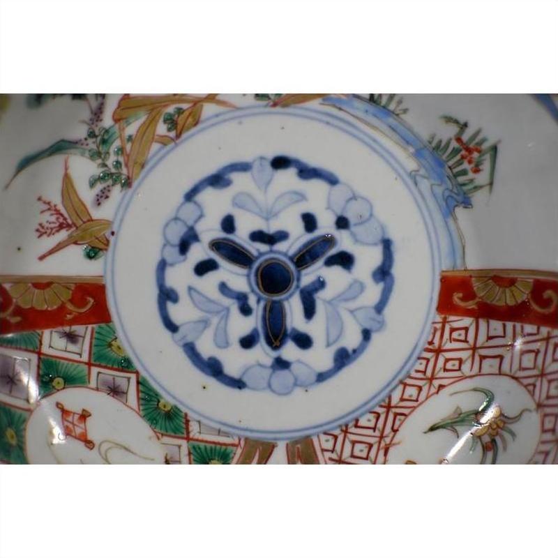 Close-up of blue and red hand painted Japanese Imari porcelain bowl with gold and green floral patterns.