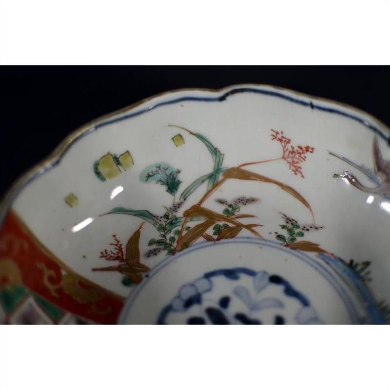 Close-up of a multicolored porcelain Japanese Imari bowl with hand-painted floral and geometric patterns.