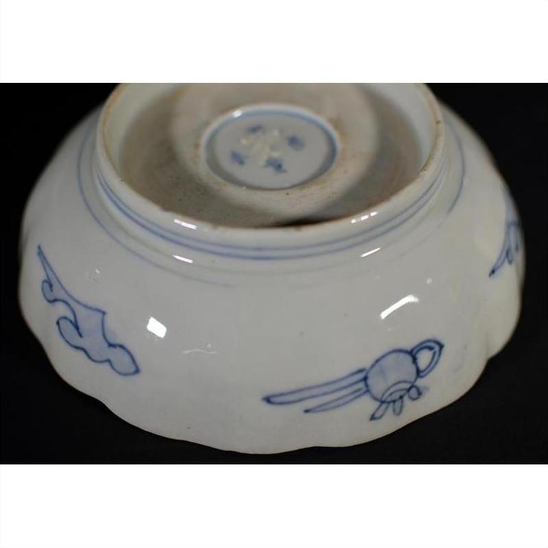 Blue and white porcelain bowl with hand painted designs and unglazed base ring, shown on a plain background.