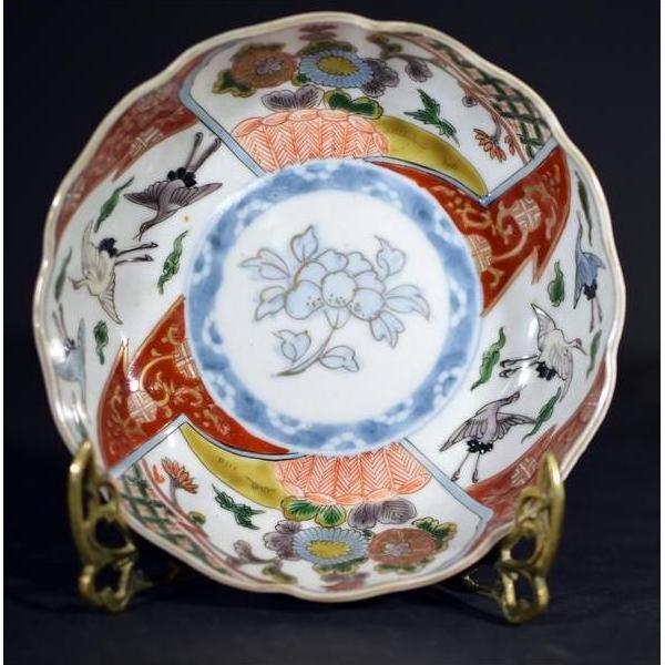 Blue and white porcelain Imari bowls with hand-painted floral and crane designs, set of 4 on ornate gold stands.