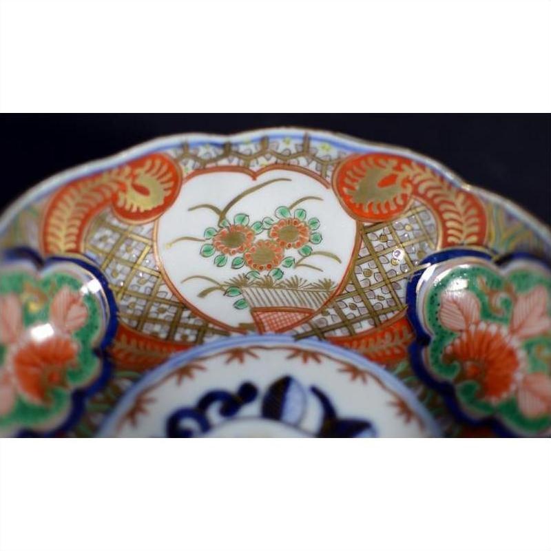 Close-up of red, green, blue, and gold floral hand painted Japanese Imari porcelain bowl.