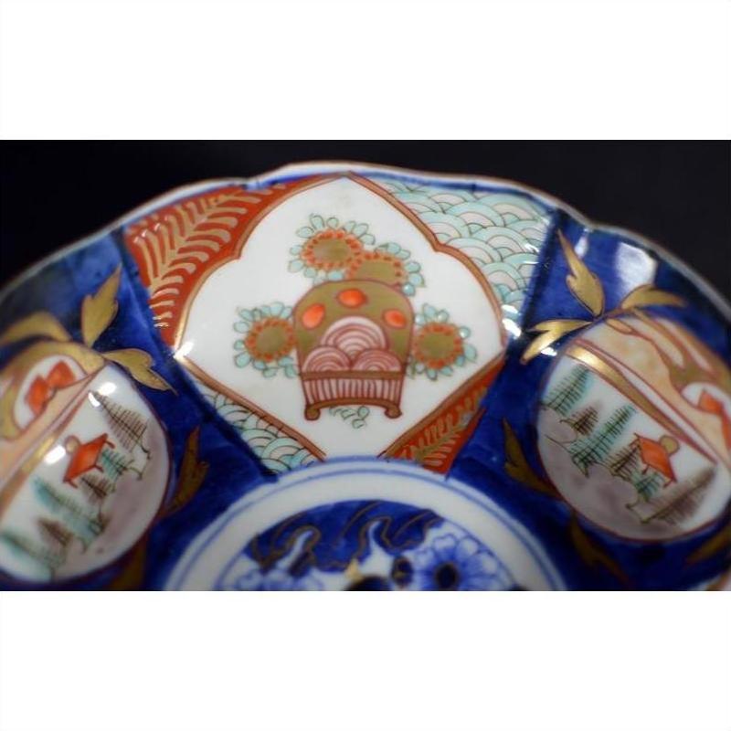 Close-up of a blue, red, and gold hand painted Japanese Imari porcelain bowl with intricate patterns.