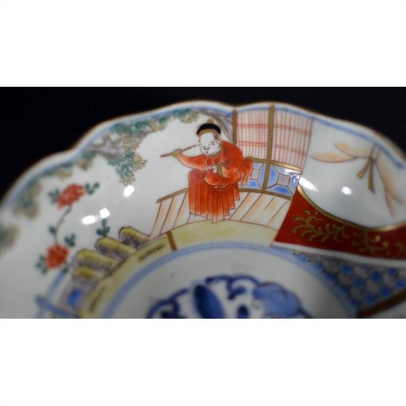 Set of 4 red and white porcelain Imari bowls with hand-painted figures in robes and floral designs, grouped together.