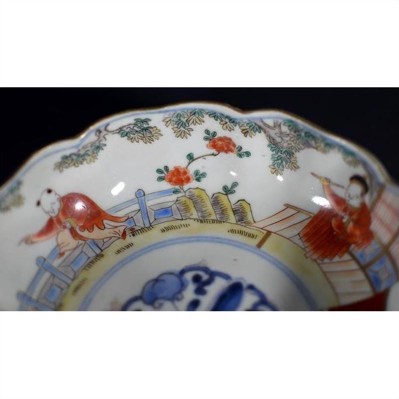 Blue, red, and white porcelain Imari bowls set of 4 with hand-painted figures and floral patterns, scalloped edges.