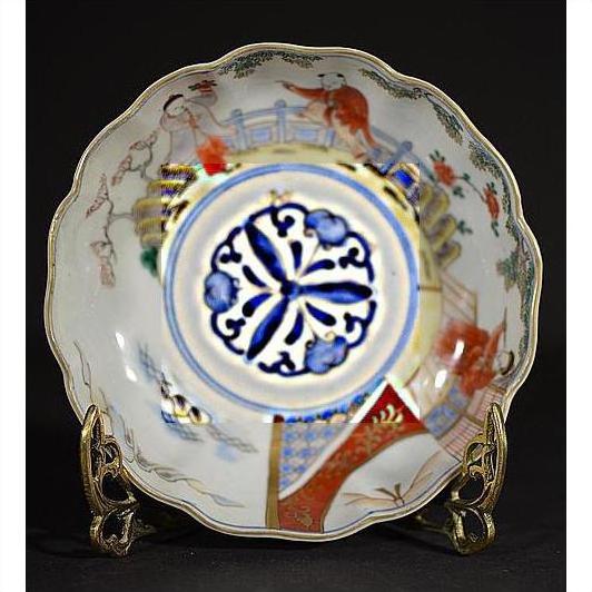 Colorful porcelain Imari bowls set of 4, hand-painted, displayed on stands against a black background.