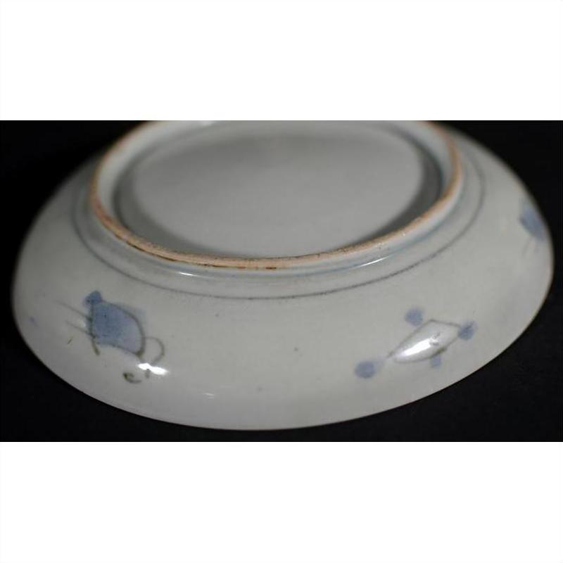 White porcelain bowl with blue edge designs, hand painted, shown upside down.