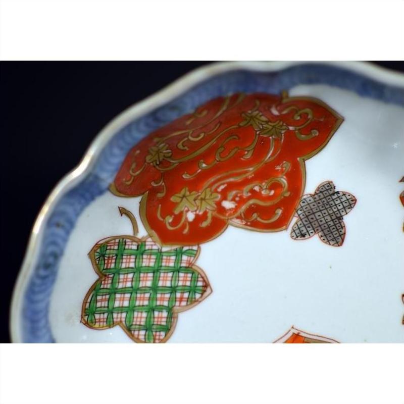 Close-up of an antique hand painted Japanese Imari porcelain bowl on a plain white background.