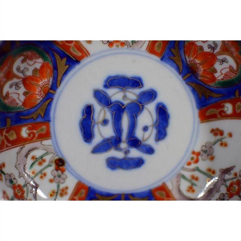 Close-up of blue, red, and orange floral patterned porcelain Japanese Imari bowl, antique, hand painted.