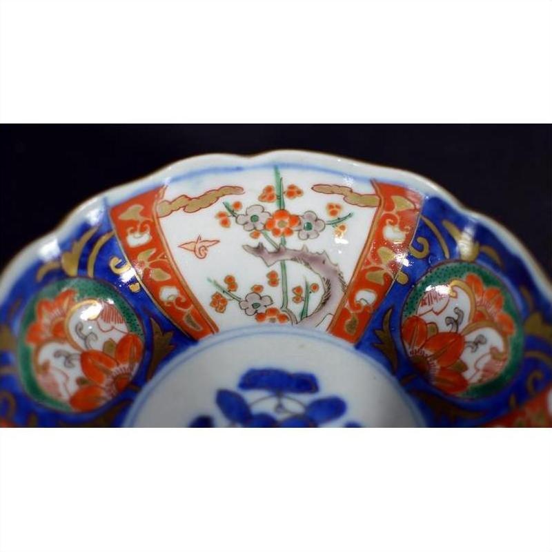Close-up of a multicolored porcelain Japanese Imari bowl with hand painted floral and geometric patterns.