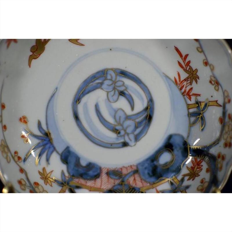 Blue, red, and gold floral Imari porcelain bowl, hand painted, antique Japanese design, seen from top view.