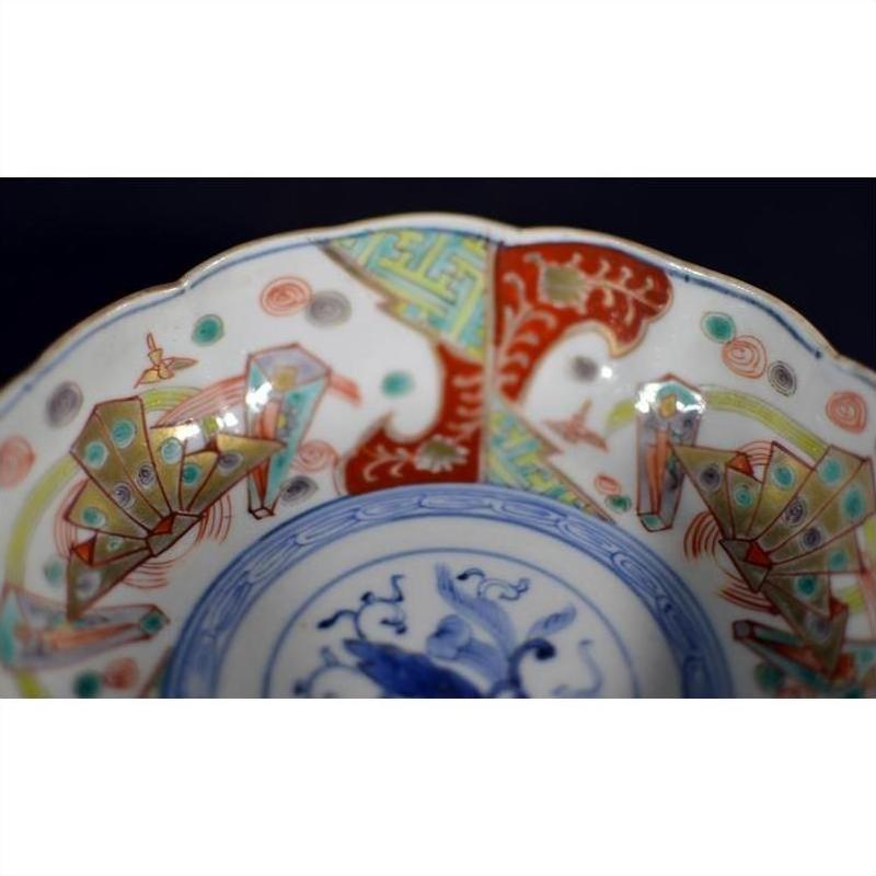 Close-up of colorful hand painted floral and geometric designs on antique Japanese Imari porcelain bowl.