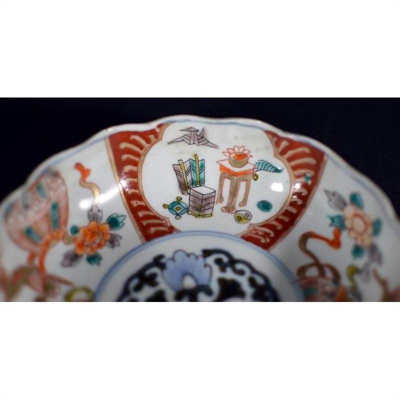 White porcelain Japanese Imari bowl with vibrant hand painted floral motifs, antique, close-up view.