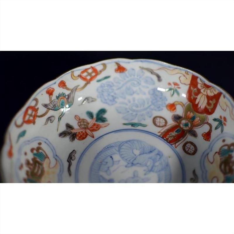 Close-up of blue, red, and gold hand painted Japanese Imari porcelain bowl with intricate designs.