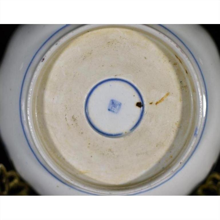 Blue porcelain bowl base close-up with blue square mark within double blue circles.