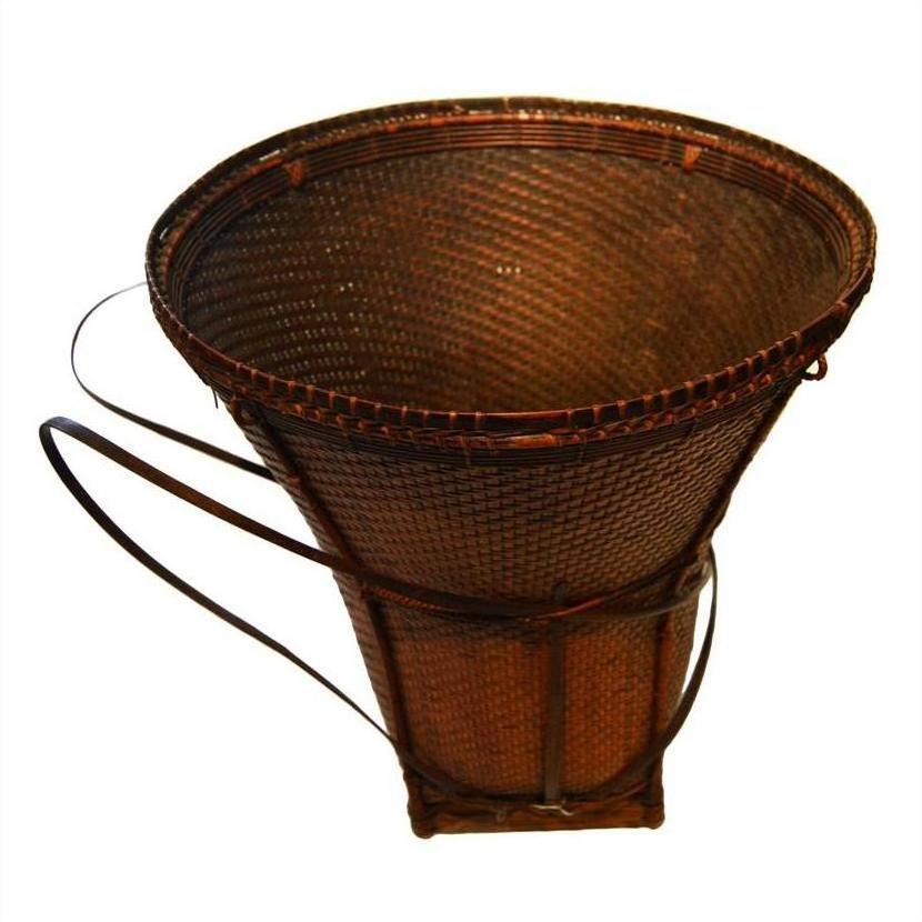 Natural rattan farmer's basket, large conical shape with two sturdy handles and wide top opening, close-up view.