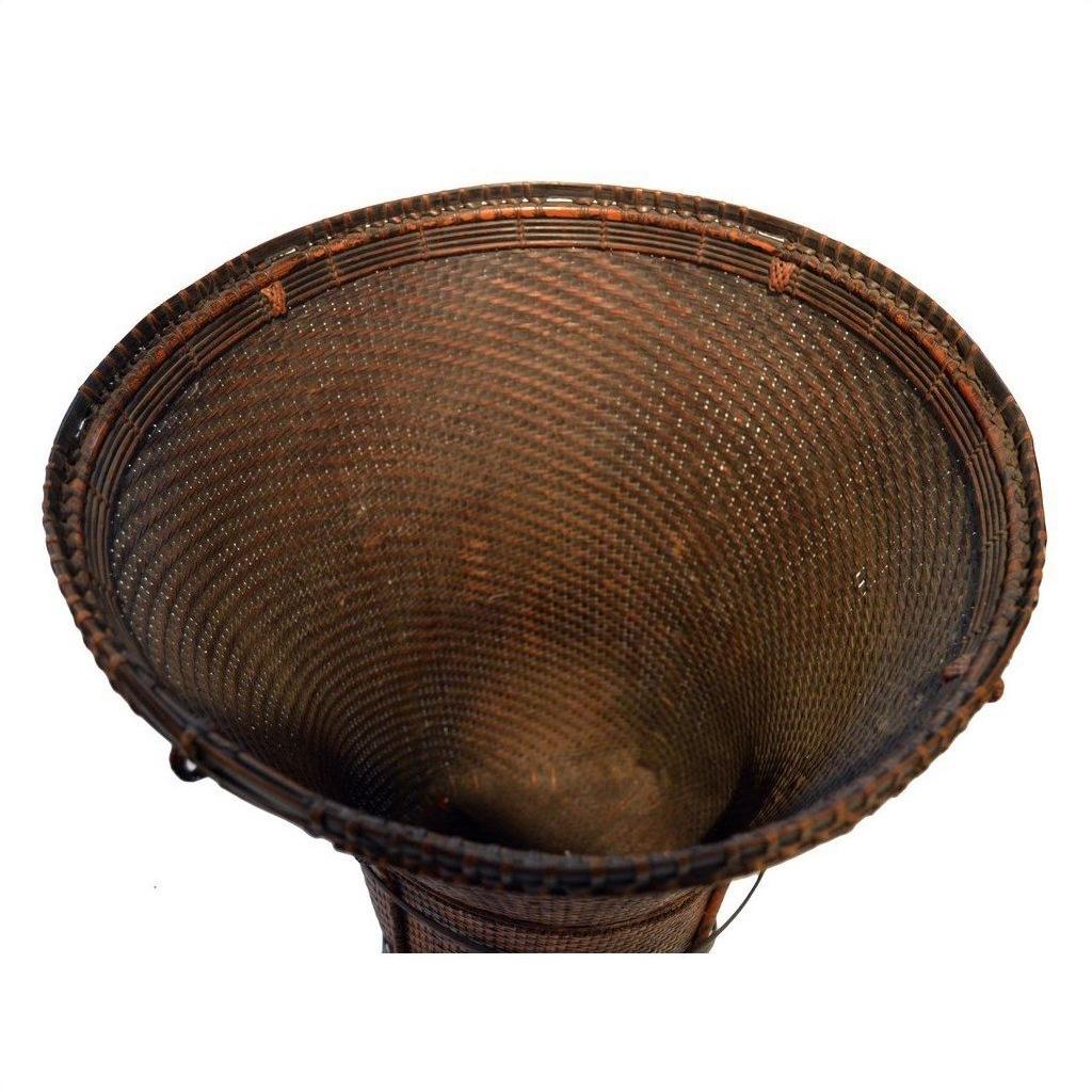 Dark brown handwoven rattan farmer's basket with flared rim, top view.