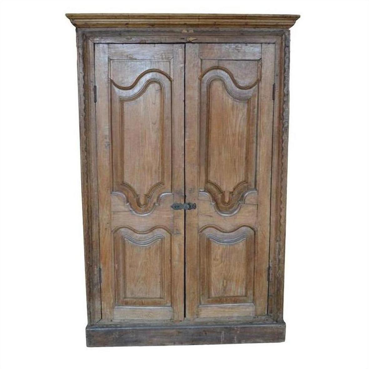 Brown wooden antique Indian cabinet with double carved doors and decorative panels, front view.