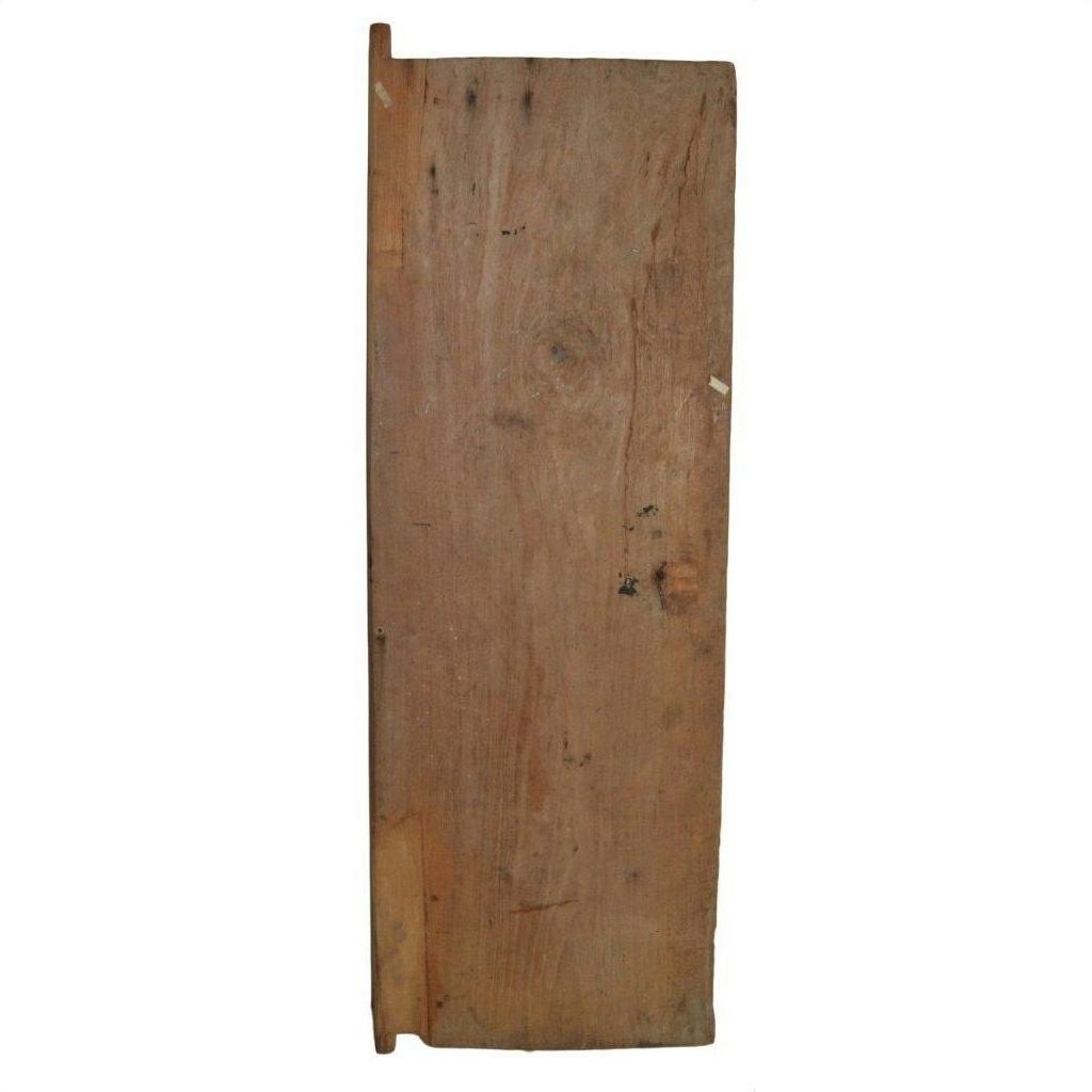 Brown antique Indian wooden door with iron hardware against plain white background.