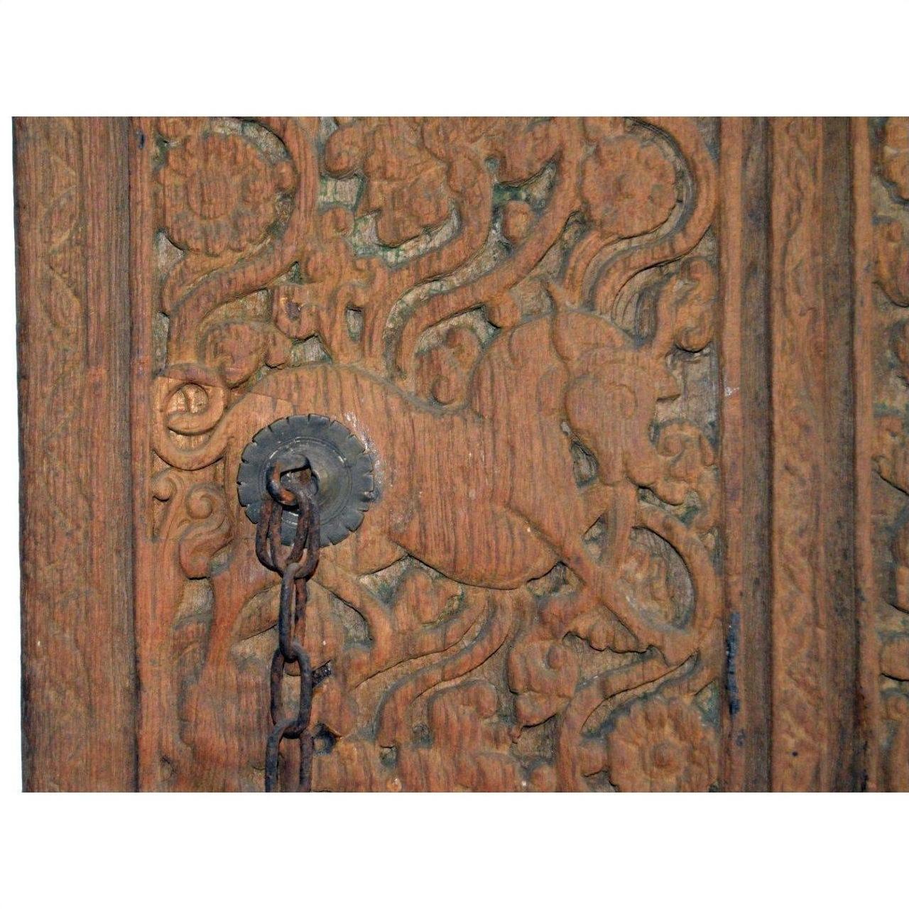 Brown sheesham wood antique Indian door with horse motifs, ornate floral carvings, and central iron hardware.