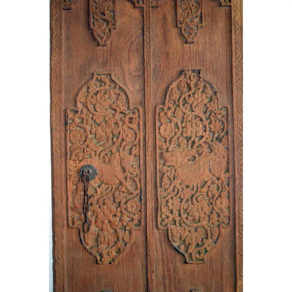 Brown wood antique Indian door with carved floral patterns, iron hardware, keyhole, and left-panel chain.