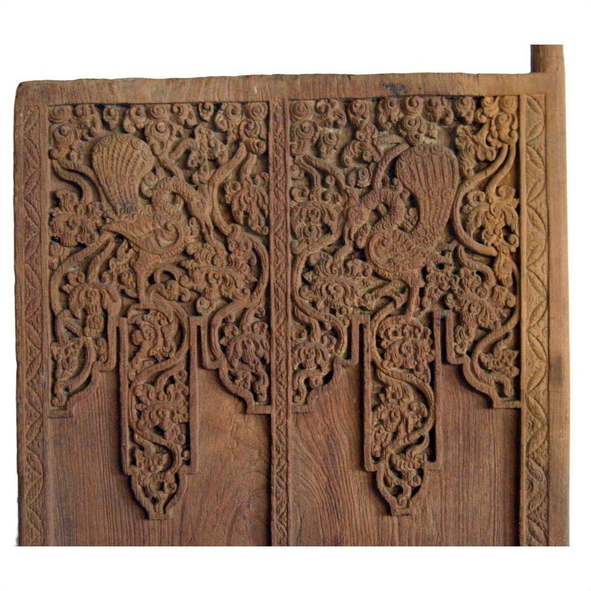 Brown Sheesham wood antique Indian door with symmetrical carved floral and bird motifs.