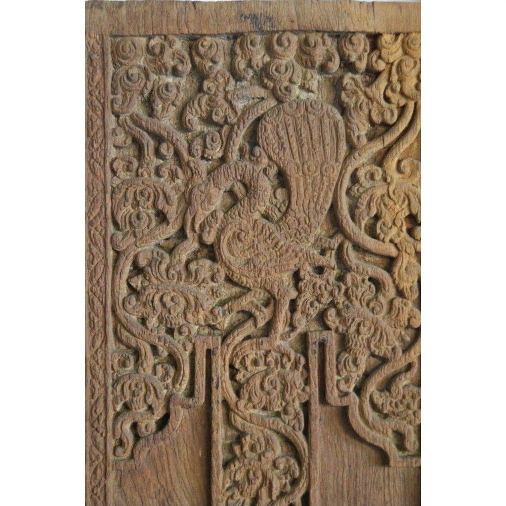 Brown Sheesham wood door with intricate carvings, featuring a stylized bird among floral and swirling patterns.