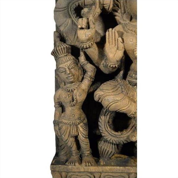 Brown sheesham wood hand-carved Indian temple decoration with standing figure in traditional attire and detailed jewelry.