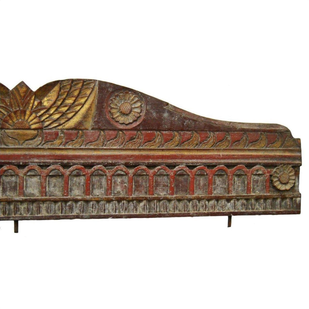 Red, gold, and brown hand carved wood wall ornament with floral and geometric designs, close-up view.