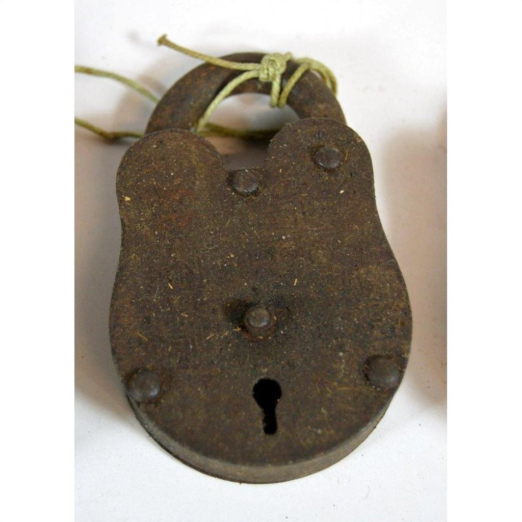 Close-up of antique metal Indian locks with keyhole and string around shackle on white background.