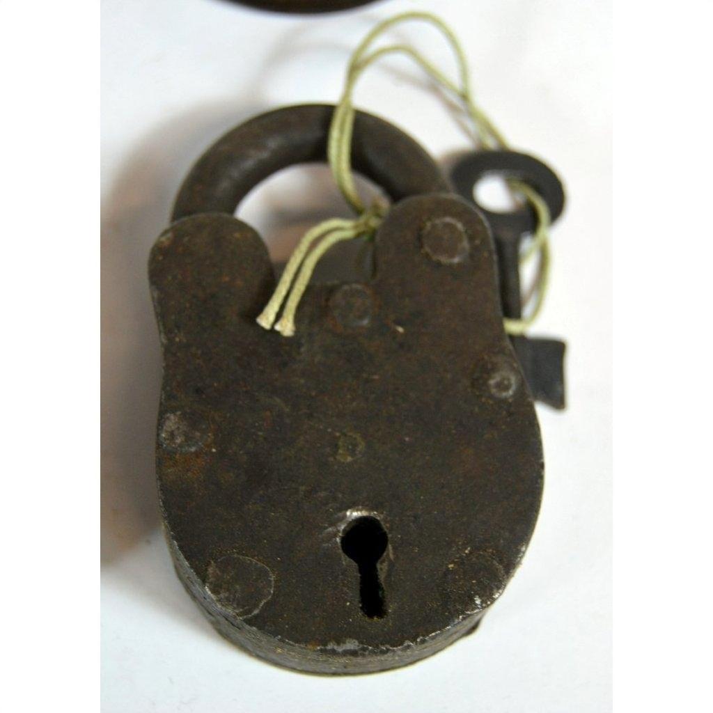 Close-up of antique metal Indian lock with key tied on string, displayed on white background.