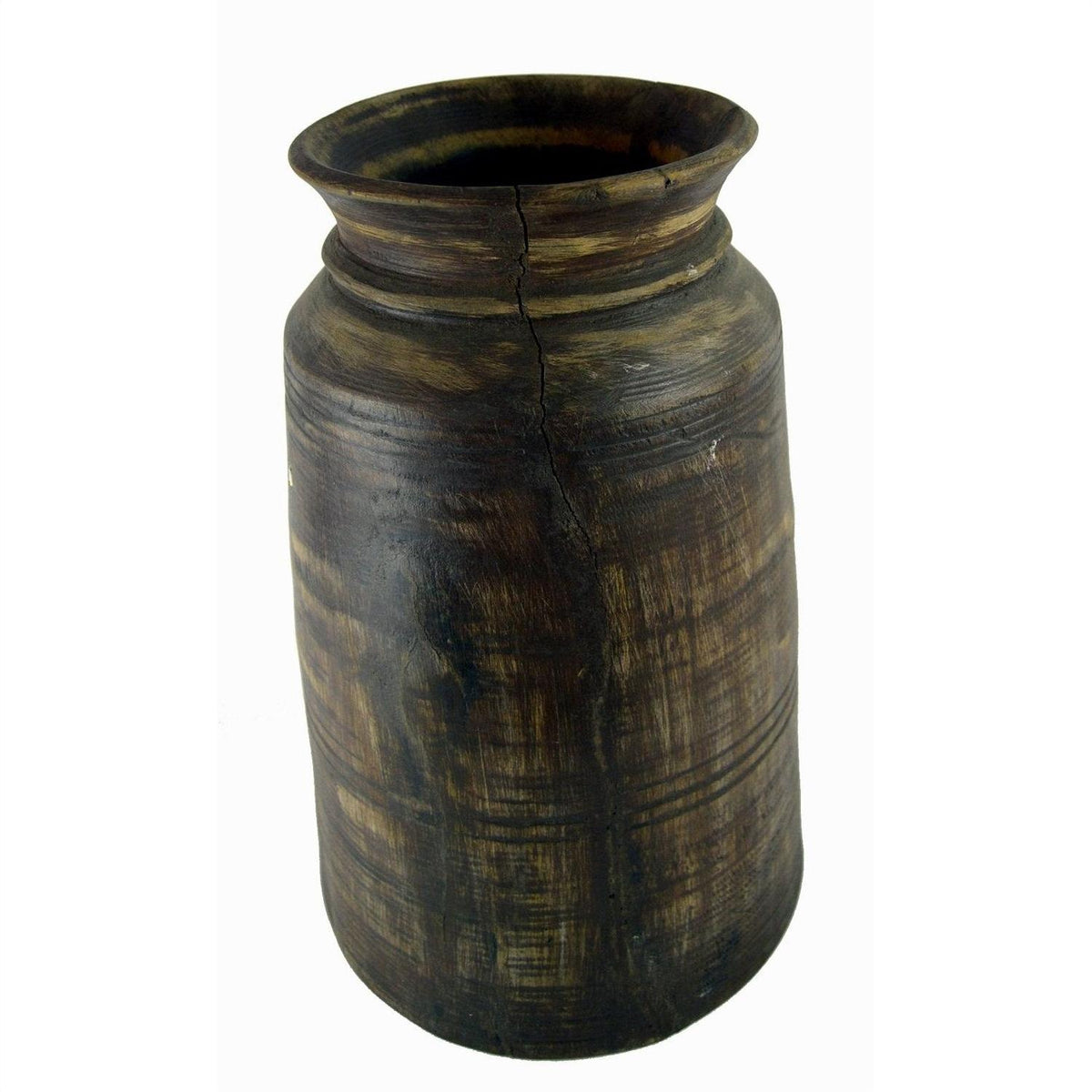 Dark brown antique Indian milk storage container, cylindrical with cracks and horizontal textured lines, close-up view.