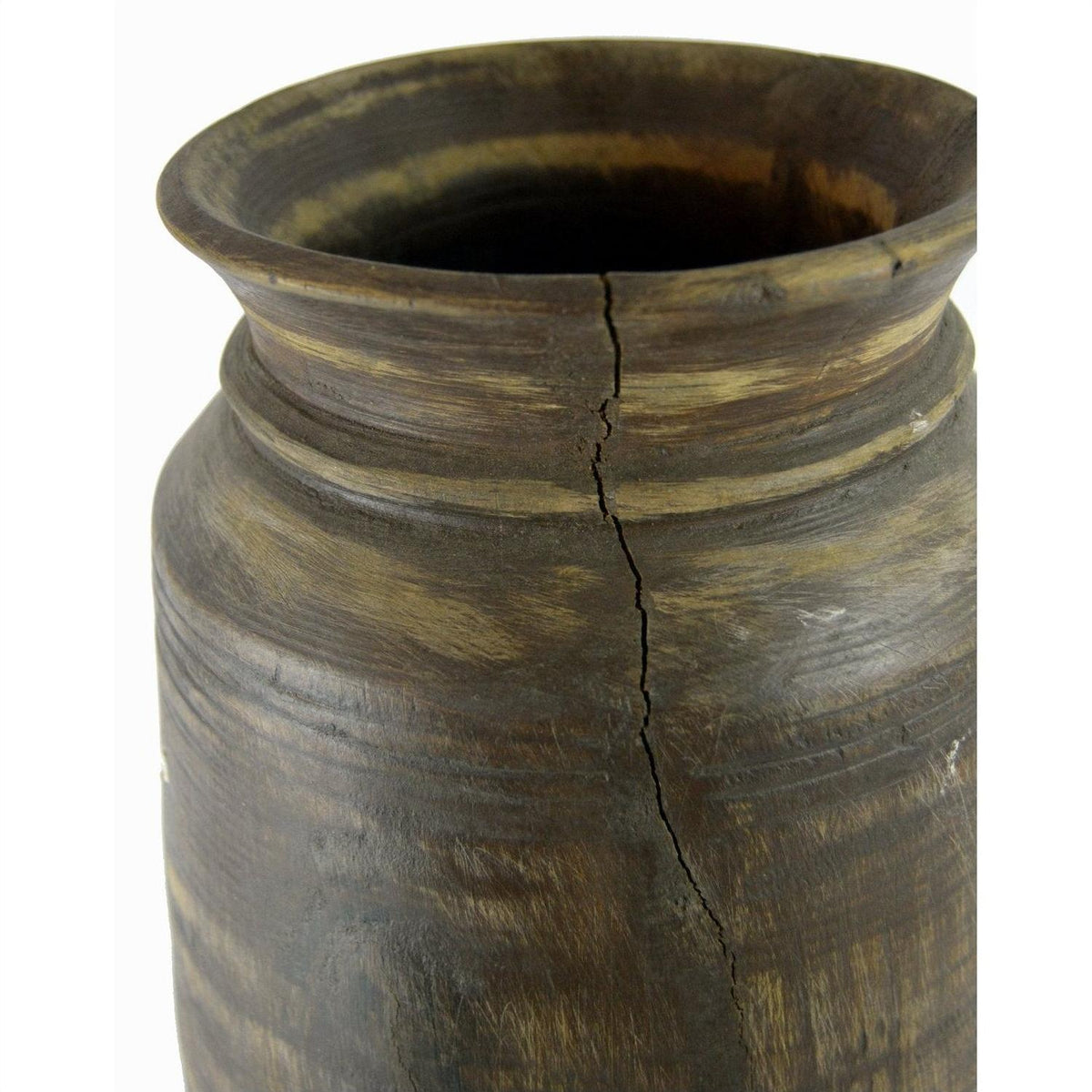Close-up of a brown antique Indian metal milk storage container with wide rim and visible vertical crack.