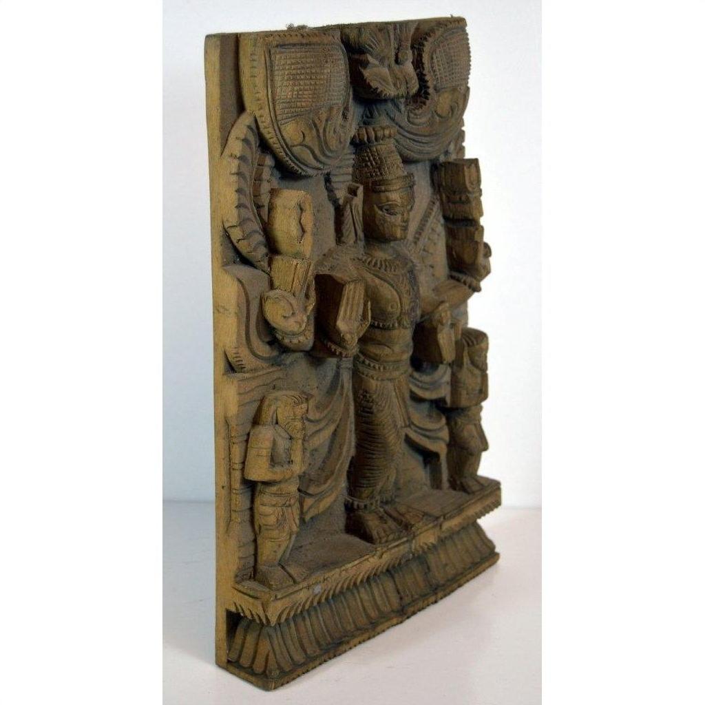 Brown sheesham wood carving of Shiva with multiple arms and attendants on decorative base, indoor display.