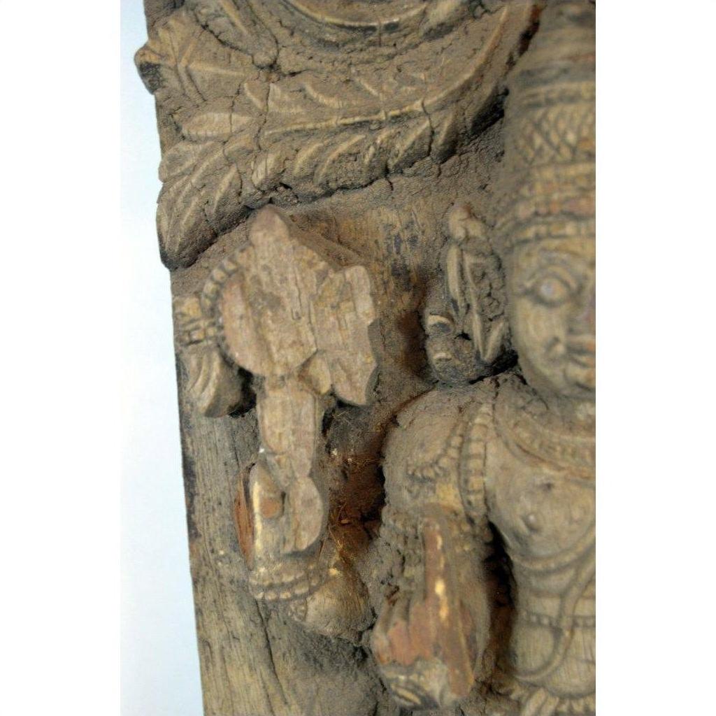 Close-up of brown Sheesham wood carving in antique Indian style, inspired by Tamil Nadu decor.