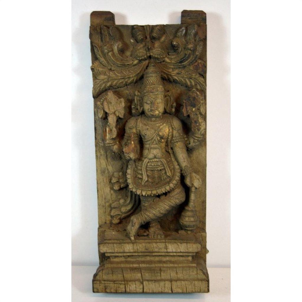 Brown Sheesham wood carving of Indian deity with intricate patterns and foliage detailing, close-up view.