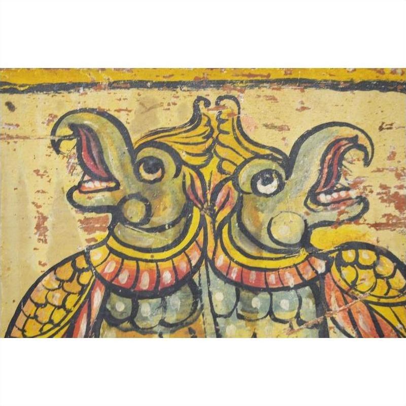 Colorful painting of two crowned bird-like creatures, inspired by antique Indian wood shrine, close-up view.