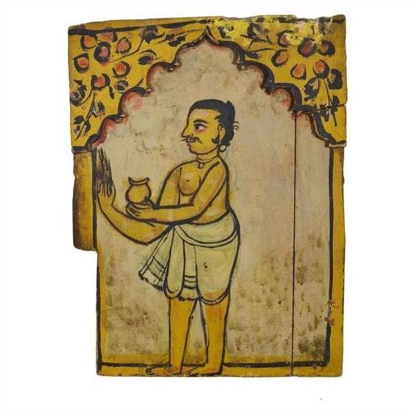 Brown wood Indian shrine with hand-painted doors, yellow arch, and a man in traditional attire holding a pot.