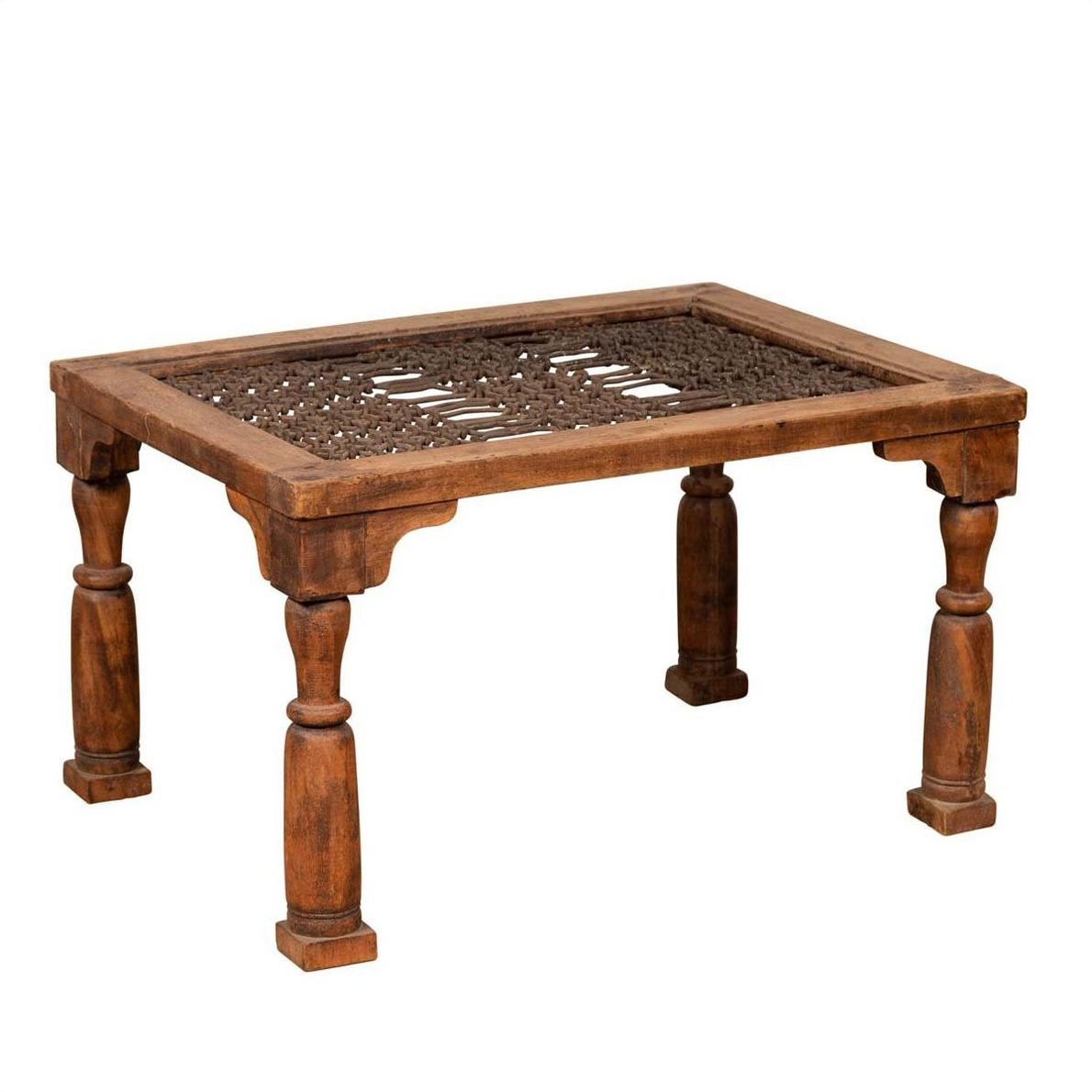 Brown wooden side table with window grate top and turned baluster legs on white background.