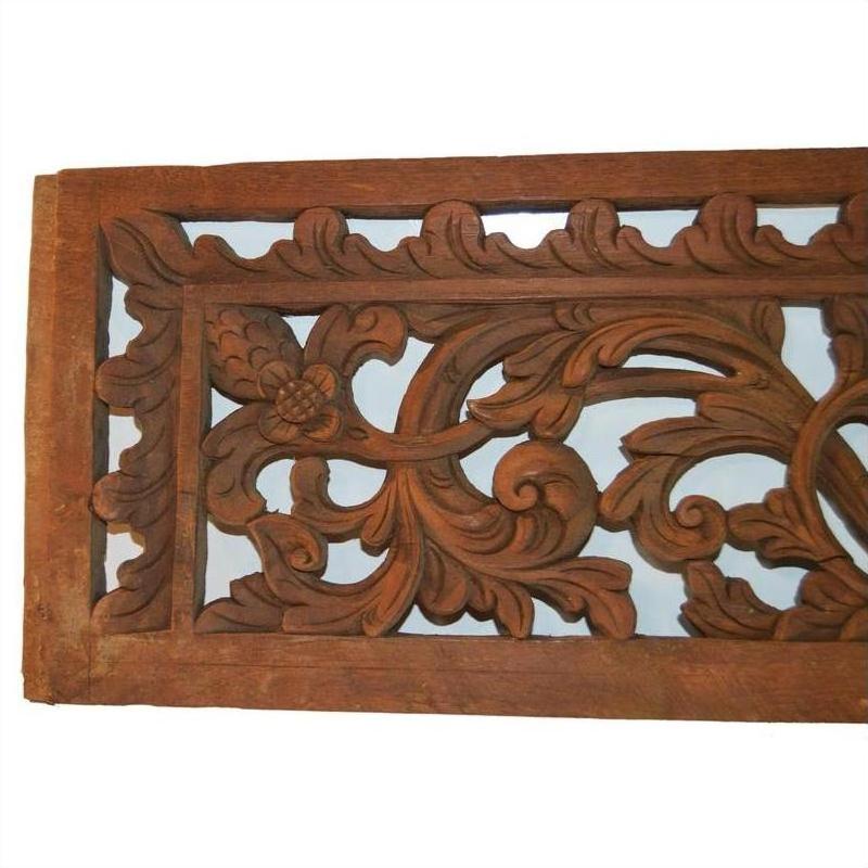 Brown wooden ornate Indonesian frame, antique carving, close-up, suitable for unique wall or exotic home décor.