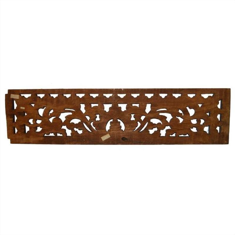 Brown wood Indonesian carving with ornate floral patterns and open cutwork, wall décor piece.
