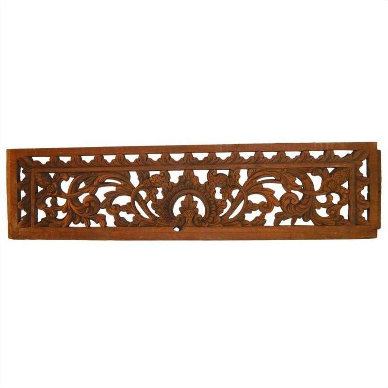 Brown wood rectangular panel with intricate floral and leaf carvings, Indonesian antique wall décor, close-up view.