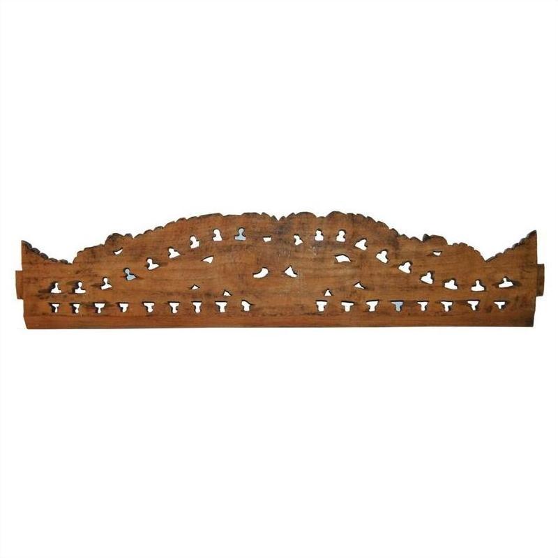 Brown wood Indonesian carving wall decor with scalloped top and geometric patterns, set against a white background.