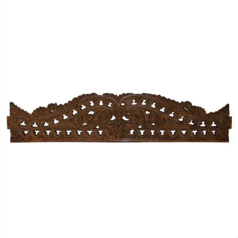 Brown wood Indonesian wall carving with ornate floral and scrollwork details on a white background.