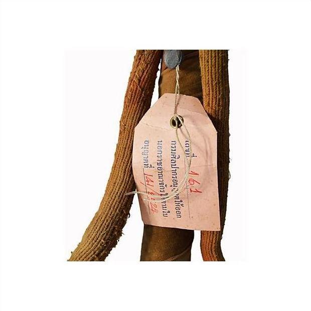 Brown paper tag with blue and red writing attached to metal sword and scabbard.