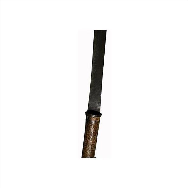 Close-up of brown textured handle and long dark blade of antique Indonesian sword, straight design.