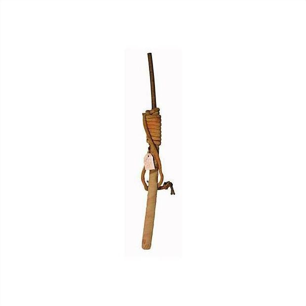 Brown wooden stick with attached rope, resembling an antique Indonesian sword scabbard, isolated on white background.