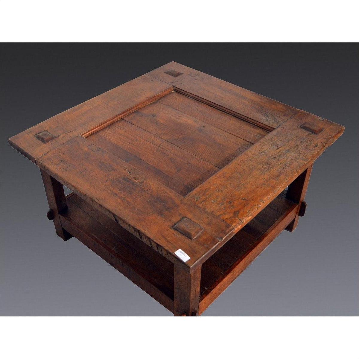 Brown wood square coffee table with rustic finish, handcrafted grain, and lower shelf, Indonesian antique style.