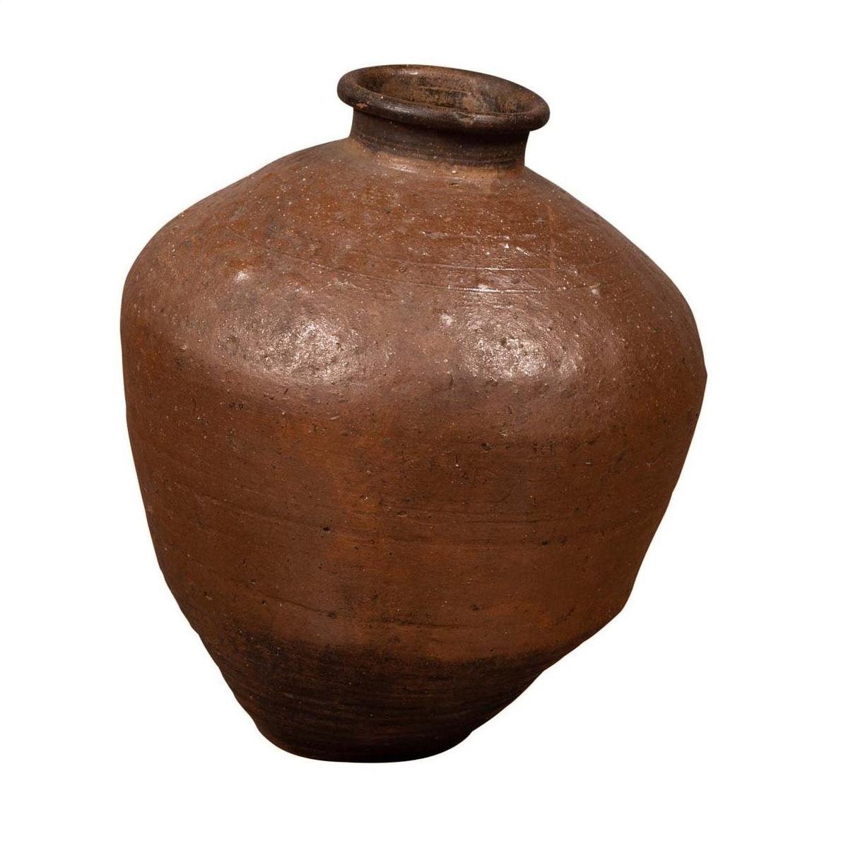 Brown ceramic Japanese oil jar with weathered finish and irregular shape, displayed on a white background.