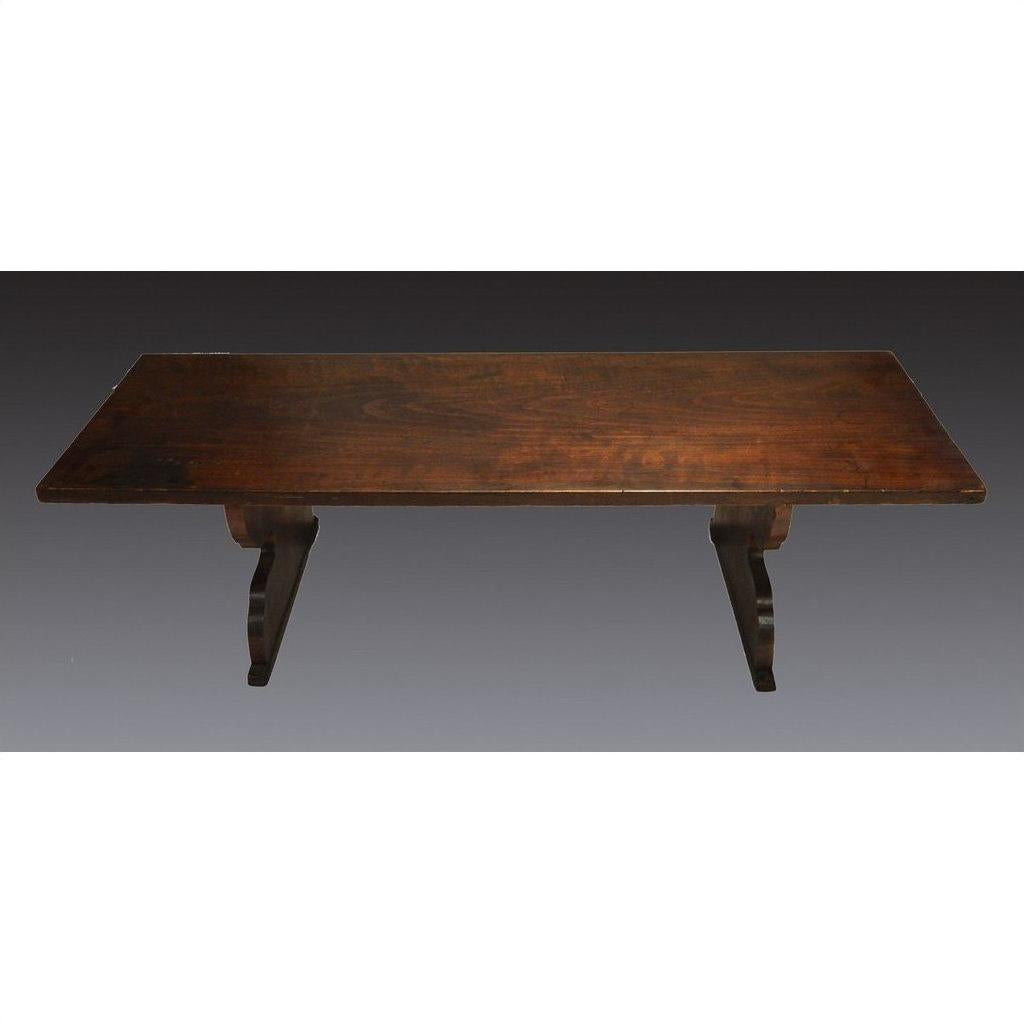 Dark wood antique Japanese desk with rectangular top and curved pedestal legs, studio background.