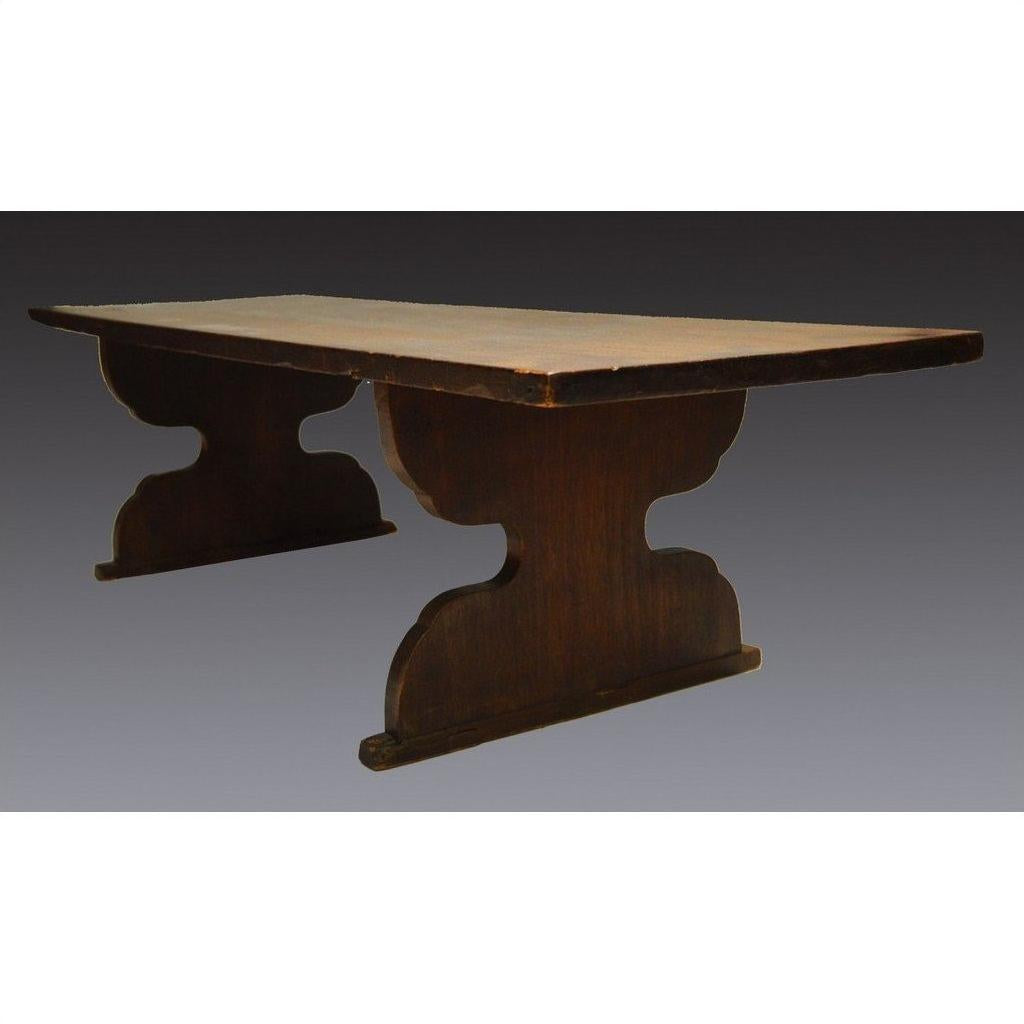 Dark wood antique Japanese desk with rectangular top and two thick pedestal legs, shown against a plain background.